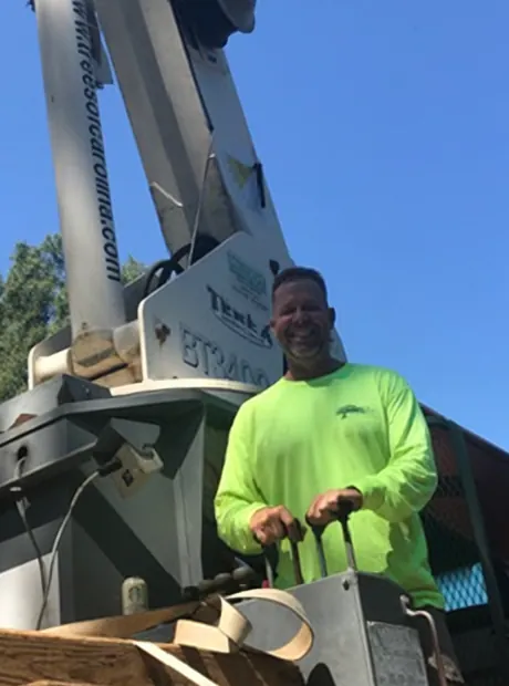 Operator in a hi-vis shirt at the controls of a Terex boom truck